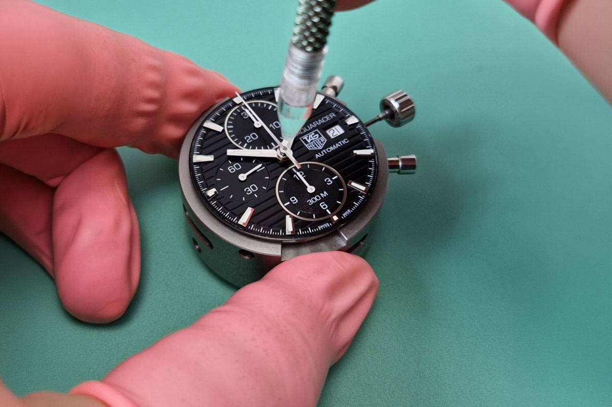 Close-up of TAG Heuer watch undergoing precision repair